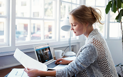 Woman at desk reading training planner